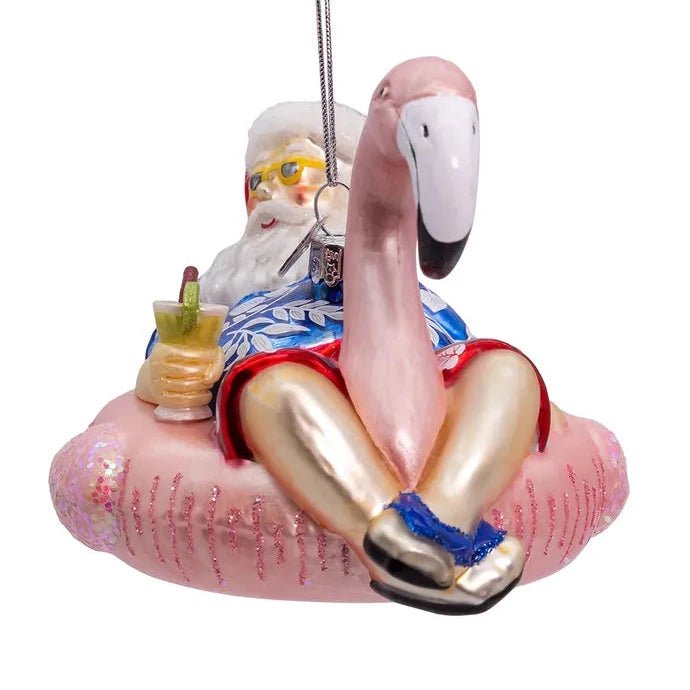 Noble Gems™ Glass Santa In Flamingo Pool Float Ornament